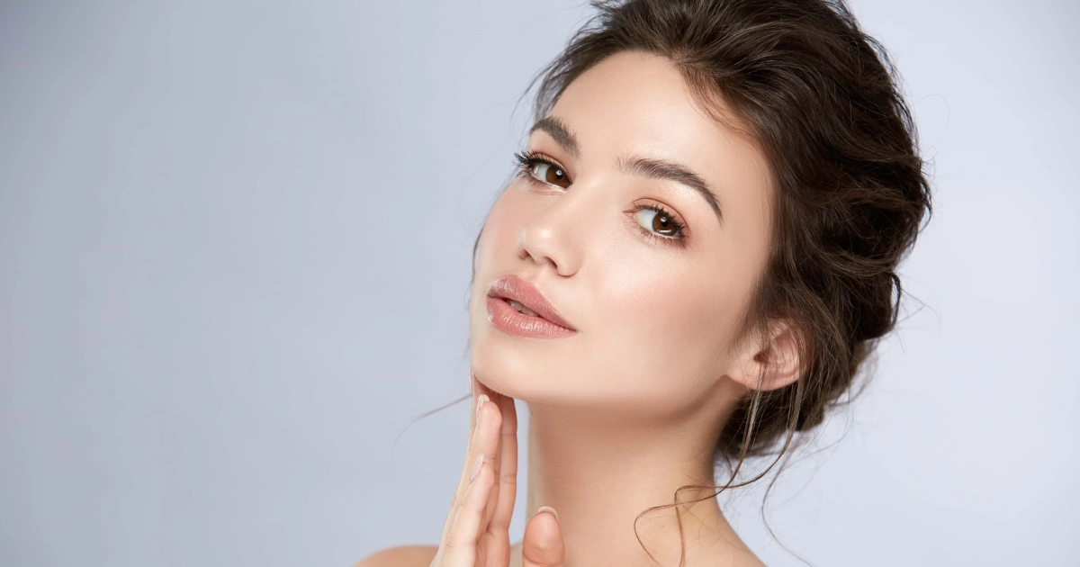 Woman showing her smooth, defined jawline after Chin Implant Surgery in Laguna Hills, CA